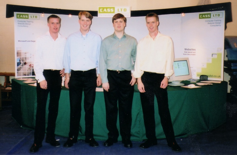 The Directors of CASS in front of the company stand at a computer fair